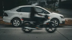 A blurry photo of a person riding a motorcycle