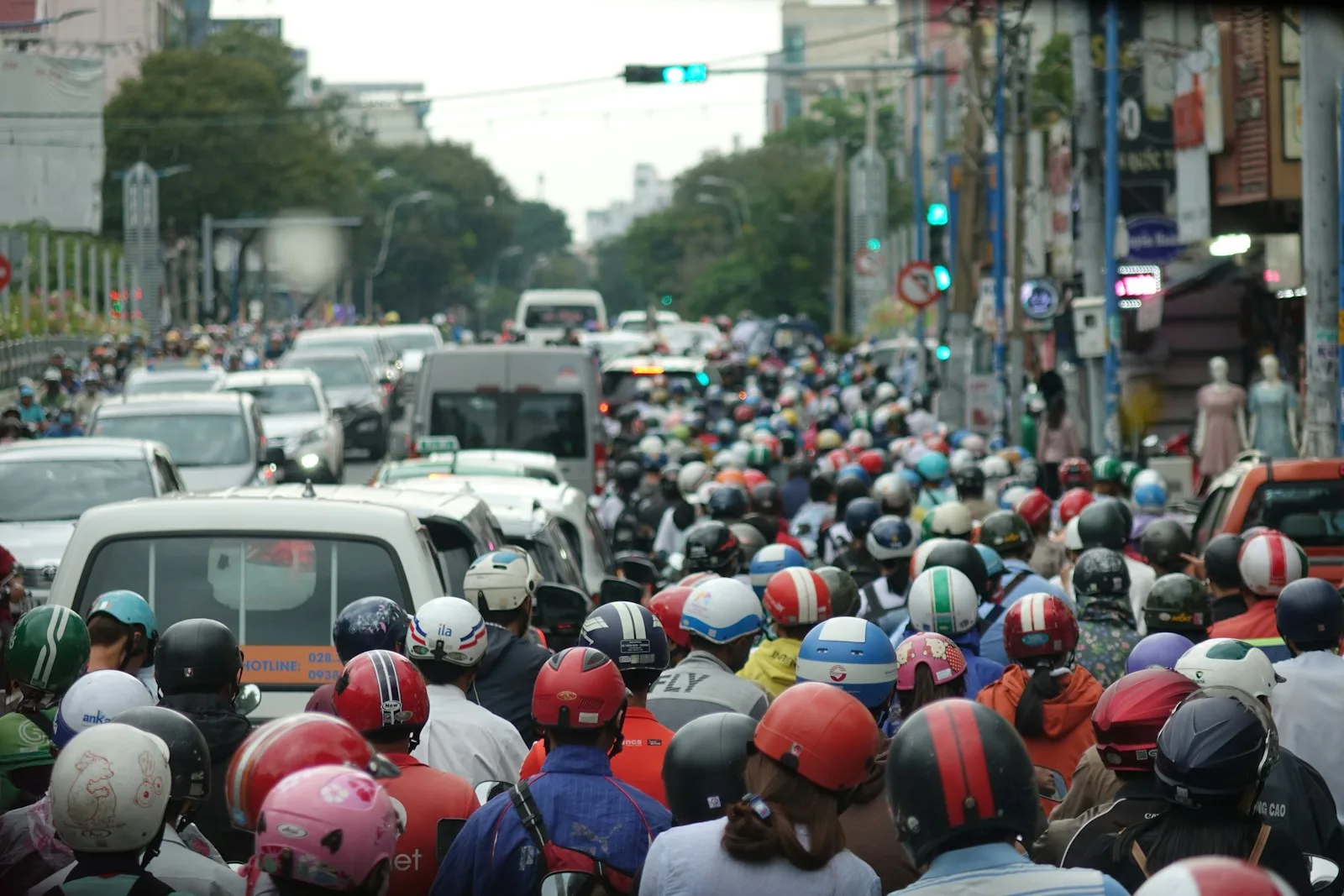 A large group of people riding motorcycles down a street