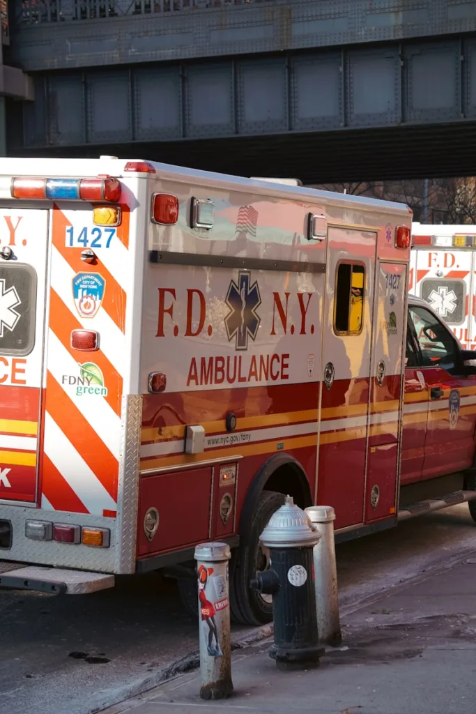 two ambulances parked next to a fire hydrant