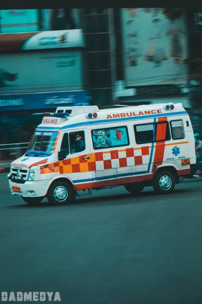 an ambulance driving down a street next to tall buildings