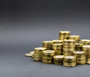 A pile of gold coins on a dark background