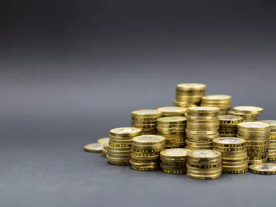 A pile of gold coins on a dark background