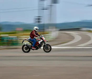 A man riding a motorcycle down a street
