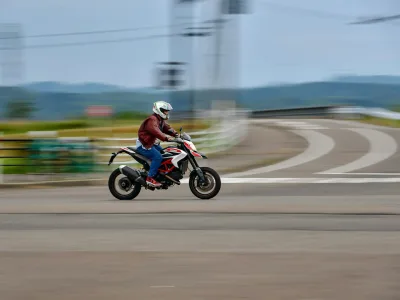 A man riding a motorcycle down a street