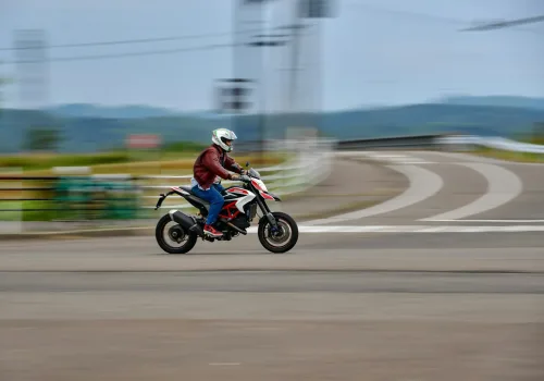 A man riding a motorcycle down a street