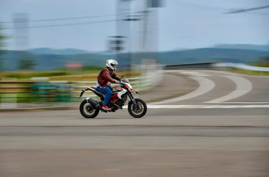 A man riding a motorcycle down a street