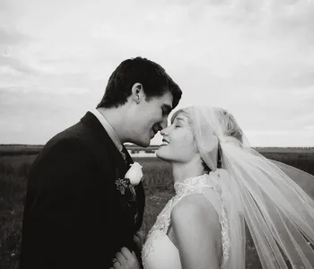 grayscale photo of man and woman kissing